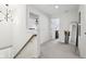 Bright hallway with carpeted floors and neutral walls, and views into other rooms at 9725 Thorne Cliff Way # 105, Fishers, IN 46037