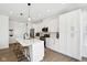 Modern kitchen with white cabinets, stainless steel appliances, kitchen island, and hardwood flooring at 9725 Thorne Cliff Way # 105, Fishers, IN 46037