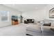 Bright living room with a TV, two sofas, and a view of the windows at 9725 Thorne Cliff Way # 105, Fishers, IN 46037