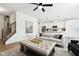 Spacious living room featuring an open floorplan, a modern staircase, and a stylish white sofa at 9725 Thorne Cliff Way # 105, Fishers, IN 46037