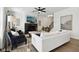 Well-lit living room featuring hardwood floors, a modern ceiling fan, and a cozy seating area at 9725 Thorne Cliff Way # 105, Fishers, IN 46037