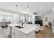 The open concept living area flows seamlessly with modern fixtures, fireplace and lots of natural light at 9725 Thorne Cliff Way # 105, Fishers, IN 46037