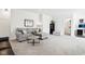 Spacious living room with a sofa, coffee table, and a view into the bathroom at 9725 Thorne Cliff Way # 105, Fishers, IN 46037