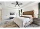 Spacious main bedroom featuring a tray ceiling, ceiling fan, neutral walls, and carpeted floors at 9725 Thorne Cliff Way # 105, Fishers, IN 46037