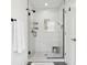 Glass enclosed tile shower with hexagon floor, white tile walls, and mounted shower caddy at 9725 Thorne Cliff Way # 105, Fishers, IN 46037