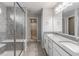 Bathroom showcasing a glass-enclosed shower, double vanity, and tile flooring, offering both style and functionality at 9800 Ridgecrest Ln, McCordsville, IN 46055