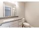 Bathroom vanity with quartz countertop, white cabinets, and framed mirror at 9800 Ridgecrest Ln, McCordsville, IN 46055