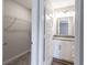 Bathroom featuring vanity, cabinets, and an adjacent closet space at 9800 Ridgecrest Ln, McCordsville, IN 46055