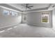 This bedroom is bright and airy with three windows, tray ceiling, ceiling fan, and neutral walls and carpet at 9800 Ridgecrest Ln, McCordsville, IN 46055