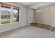 Bedroom with two bright windows, neutral walls, and transition to wood flooring at 9800 Ridgecrest Ln, McCordsville, IN 46055