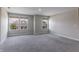 Bright bonus room with plush carpeting and windows providing abundant natural light, creating a welcoming atmosphere at 9800 Ridgecrest Ln, McCordsville, IN 46055