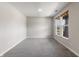 Spacious empty room with neutral carpet, light gray walls, and natural light from two windows at 9800 Ridgecrest Ln, McCordsville, IN 46055