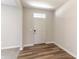 Bright entryway with hardwood floors, a white door, and neutral-colored walls at 9800 Ridgecrest Ln, McCordsville, IN 46055