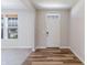 Welcoming entryway featuring hardwood floors, a white front door, and a view to a nearby window at 9800 Ridgecrest Ln, McCordsville, IN 46055