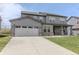 Gorgeous two-story home with gray siding, bright windows, and a spacious two-car garage at 9800 Ridgecrest Ln, McCordsville, IN 46055