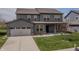 Attractive two-story home featuring gray siding, brick accents, and an attached two-car garage at 9800 Ridgecrest Ln, McCordsville, IN 46055