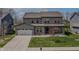 Inviting two-story home with gray siding, green lawn, and a convenient two-car garage at 9800 Ridgecrest Ln, McCordsville, IN 46055