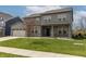 Attractive two-story home with gray siding, brick accents, and an attached two-car garage at 9800 Ridgecrest Ln, McCordsville, IN 46055