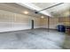 Spacious garage with concrete floor, overhead lighting, and drywall walls ready for paint at 9800 Ridgecrest Ln, McCordsville, IN 46055