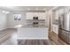 Eat-in kitchen with white cabinets, island and stainless steel refrigerator at 9800 Ridgecrest Ln, McCordsville, IN 46055