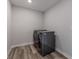 Laundry room featuring gray washer and dryer with laminate flooring at 9800 Ridgecrest Ln, McCordsville, IN 46055