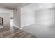 Open-concept living room has both hardwood and carpeted areas and neutral walls at 9800 Ridgecrest Ln, McCordsville, IN 46055