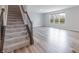 View of the carpeted staircase adjacent to open-concept living room at 9800 Ridgecrest Ln, McCordsville, IN 46055