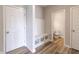 Well-organized mudroom with storage and seating, leading to a convenient half bathroom at 9800 Ridgecrest Ln, McCordsville, IN 46055