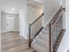 Carpeted staircase with dark wood railing leads to the upper level at 9800 Ridgecrest Ln, McCordsville, IN 46055