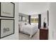 Inviting bedroom featuring natural light, stylish decor, and framed art above the bed at 995 Penrose Pl, Danville, IN 46122