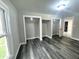 Bedroom featuring gray wood-look floors, built-in closets, and a window at 1001 N 14Th St, Elwood, IN 46036