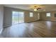 Spacious living room with new floors, sliding glass doors, and plenty of natural light at 1001 N 14Th St, Elwood, IN 46036