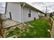 Exterior view of home featuring a quaint backyard with a patio and new wood fence at 1008 E Apple Lake Dr, Greenfield, IN 46140