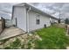Exterior view of home featuring a quaint backyard with a patio and new wood fence at 1008 E Apple Lake Dr, Greenfield, IN 46140