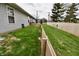 View of backyard showing lawn and wood fence along side of home at 1008 E Apple Lake Dr, Greenfield, IN 46140