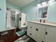 Features a modern vanity, white cabinets, white framed mirror, and a shower with sliding glass door at 1008 E Apple Lake Dr, Greenfield, IN 46140