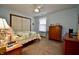 Inviting bedroom includes bright walls, carpeting, and a queen size bed at 1008 E Apple Lake Dr, Greenfield, IN 46140