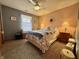 Cozy bedroom features carpeting, a queen bed, and a ceiling fan at 1008 E Apple Lake Dr, Greenfield, IN 46140