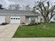 Inviting single-story home featuring brick accents, a well-kept lawn, and covered front porch at 1008 E Apple Lake Dr, Greenfield, IN 46140