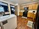 Well-lit kitchen features wooden cabinets, dark appliances, and wood floors at 1008 E Apple Lake Dr, Greenfield, IN 46140