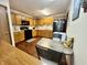 Bright kitchen features wood cabinets, laminate flooring, and sleek black appliances at 1008 E Apple Lake Dr, Greenfield, IN 46140