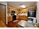 Bright kitchen features wood cabinets, black appliances, wood floors, and a table at 1008 E Apple Lake Dr, Greenfield, IN 46140