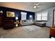 Comfortable living room features a sectional, leather recliner, and a dark accent wall at 1008 E Apple Lake Dr, Greenfield, IN 46140