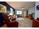 Spacious living room featuring carpet, dark blue accent wall, sectional, and a comfortable recliner at 1008 E Apple Lake Dr, Greenfield, IN 46140