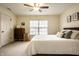 Comfortable bedroom features neutral tones, plush carpeting, and a ceiling fan for added comfort at 1057 3Rd Nw Ave, Carmel, IN 46032