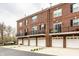 Brick townhomes with garages, balconies, and lush landscaping provide comfort and style at 1057 3Rd Nw Ave, Carmel, IN 46032