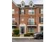 Charming brick townhouse featuring black shutters, dormer windows, and a well-maintained front garden at 1057 3Rd Nw Ave, Carmel, IN 46032