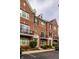 Attractive brick townhomes with black shutters, Juliette balconies, and manicured landscaping at 1057 3Rd Nw Ave, Carmel, IN 46032