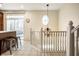 Bright hallway with staircase, leading to the kitchen and balcony at 1057 3Rd Nw Ave, Carmel, IN 46032