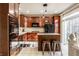 Well-lit kitchen featuring updated cabinets, stainless steel appliances, and a cozy island with seating at 1057 3Rd Nw Ave, Carmel, IN 46032